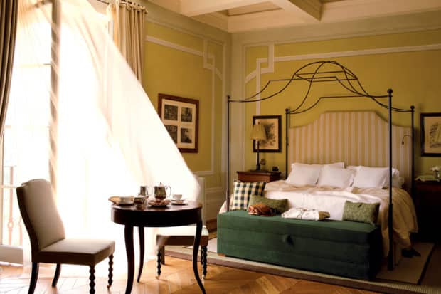 A romantic bedroom catches a breeze at Rosewood Castiglion del Bosco in Tuscany, Italy.