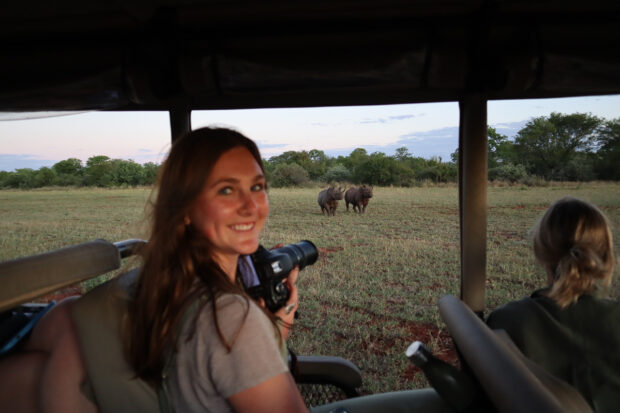 Indagare's Bridget McElroy, with two black rhinos in the background. Courtesy Indagare