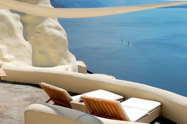 lounge chairs on patio overlooking ocean in Greece