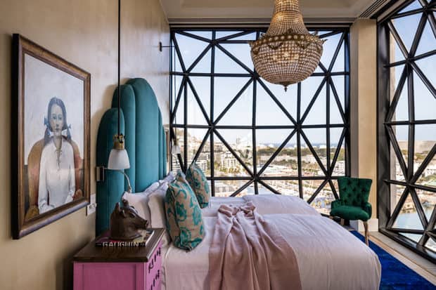 Bed under chandelier at The Silo, Cape Town