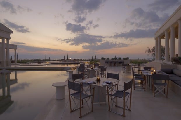 Outdoor dining area at sunset at Amanzoe in Greece